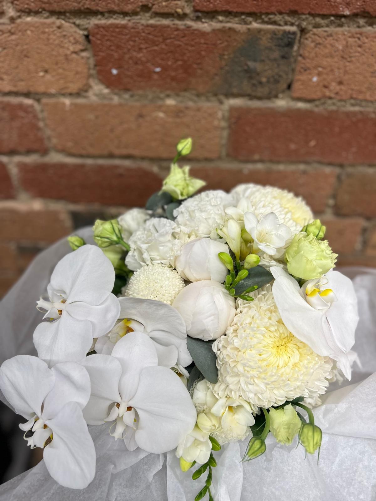 White rose and orchid bridal bouquet supplied by The Flower Merchant
